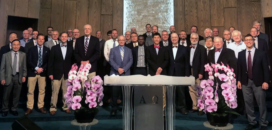 Delegates and observers at the 45th NAPARC annual meeting, gathered around the pulpit at Rohthem Presbyterian Church in Anaheim, California