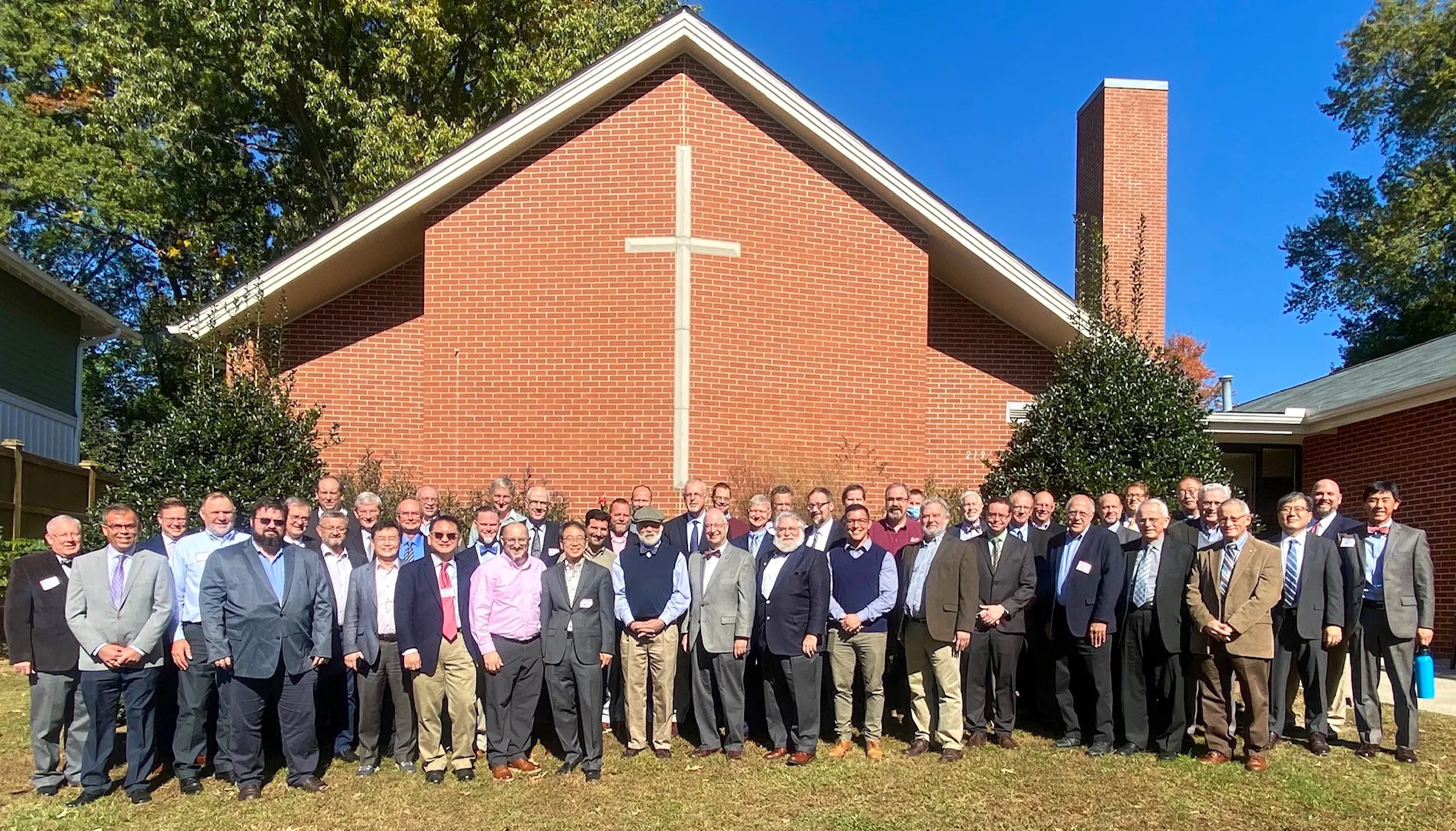 Delegates and observers at the 46th NAPARC annual meeting, standing on the lawn outside Shiloh Orthodox Presbyterian Church in Raleigh, North Carolina